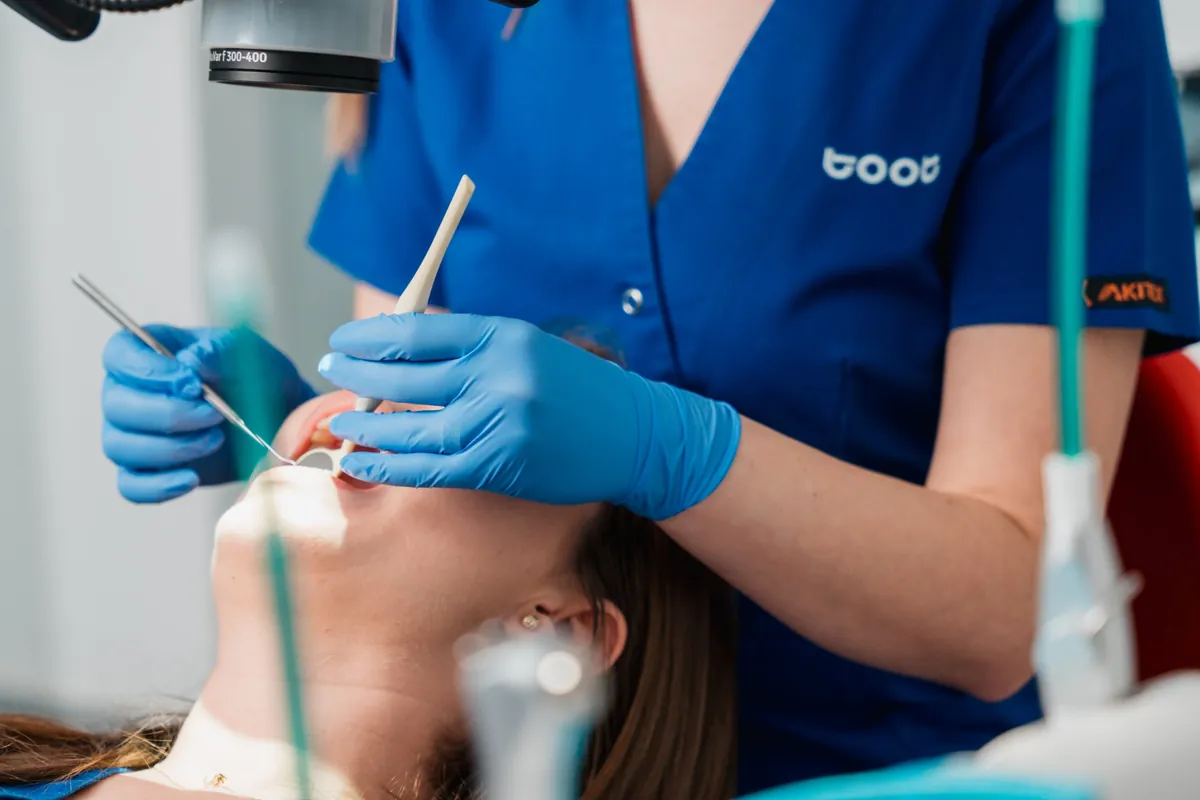 Medic Toot Studio Dentar examinând un pacient, sub microscop